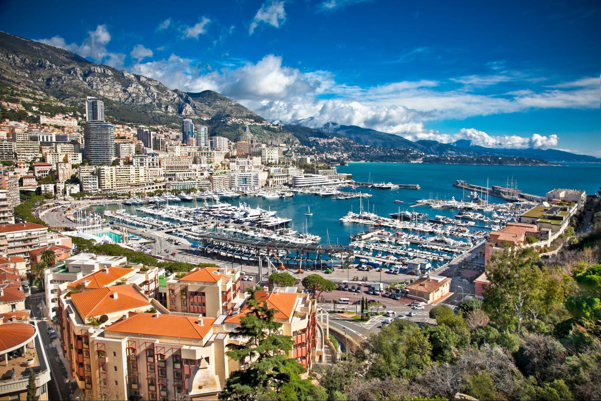 Yachts docked in Monaco's marina on a clear day