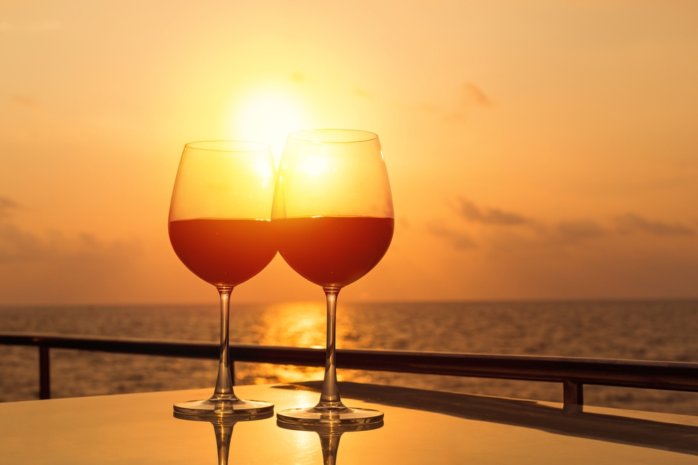 Two glasses of red wine on the yacht deck at sunset
