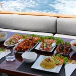 Food prepared and presented on a table in the yacht exterior.
